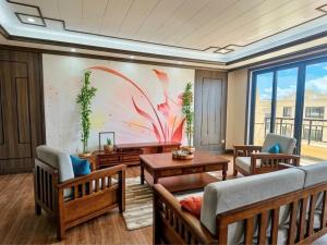 a living room with a large painting on the wall at Seaview Garden Hotel & Residences in Trinity