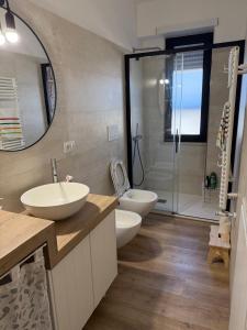 a bathroom with two sinks and a shower at Pepe Apartments Asy in Castellammare di Stabia +13 photos