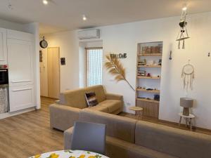 a living room with a couch and a table at Pepe Apartments Asy in Castellammare di Stabia