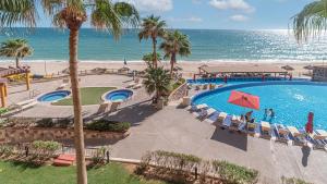 an aerial view of a resort with a swimming pool and the beach at Vacation Paradise Relaxing Ocean Front Condo in Puerto Peñasco