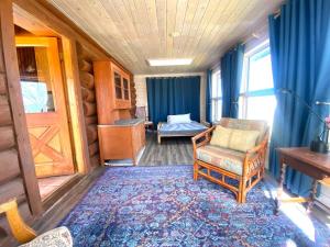a room with a bedroom with a bed and a chair at Selway View Cabin in Corvallis