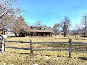 a wooden fence in front of a house at Selway View Cabin in Corvallis