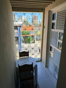 a table and two chairs on a balcony with a view at Pousada Extensão Sabrinna in Maceió