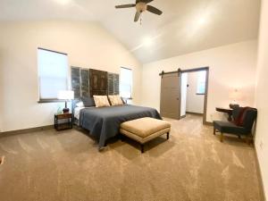 a bedroom with a bed and a chair and a fan at Comfy 4 Bdrm House with Air Conditioning in Corvallis