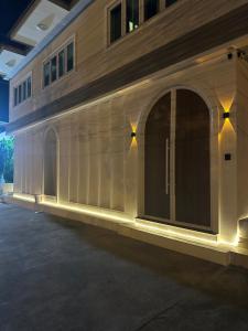 a building with a window with lights on it at Villa LaMoon in Sattahip