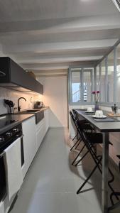 a kitchen with a table and a counter top at Fontana Maggiore View Suite in Perugia