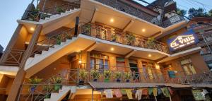 a building with balconies and a sign on it at CL Villa Manali in Manāli
