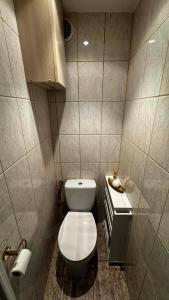 a small bathroom with a toilet and a sink at Cracow View Rooms in Krakow