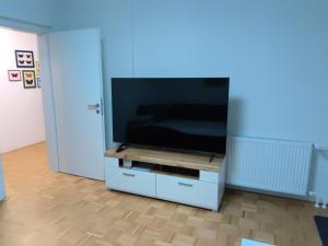 a flat screen tv sitting on a white entertainment center at Apartma Gašper in Šentjur