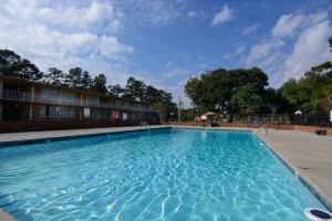 a swimming pool at a hotel with blue water at Calloway Inn and Suites in Hammond