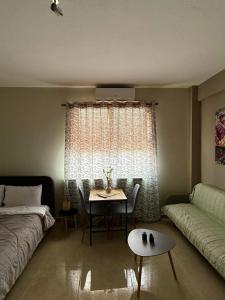 a living room with a table and a couch at Alpha apartment 43 in Serres