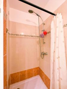 a shower with a white shower curtain in a bathroom at Mediterranean Garden in Agde +27 photos