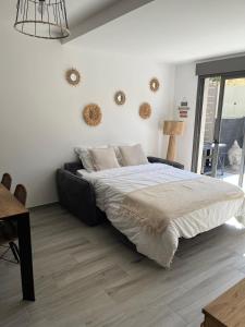 a bedroom with a large bed and a table at Casa ELYVMY in Zonza +12 photos