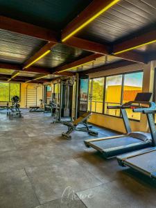 a gym with several treadmills and elliptical machines at Studio perfeito na Rota de Milagres in Pôrto de Pedras