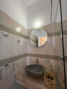 a bathroom with a stone sink and a mirror at Το Αίθριο in Galissas +34 photos