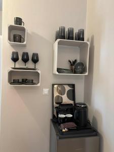a kitchen with a shelf with pots and pans at Το Αίθριο in Galissas