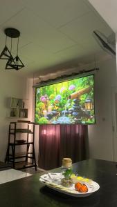 a projection screen in a room with a plate of food at Studio 1 chambre in Port-Gentil +15 photos