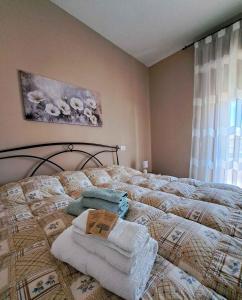 a bedroom with a bed with towels on it at La casa di Memy Bed & Breakfast in Gualdo Tadino