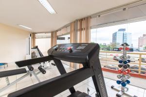 a gym with a treadmill and a large window at Hotel Metropolitan Canoas in Canoas +46 photos