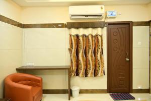 a hospital room with a door and a curtain at VRJInn in Vellore