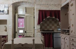 a kitchen with a table in a doll house room at Casa Renza in Locorotondo