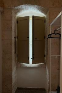 a bathroom with a window in a stone wall at Casa Renza in Locorotondo +5 photos