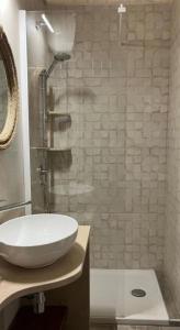 a bathroom with a white sink and a shower at Casa Renza in Locorotondo