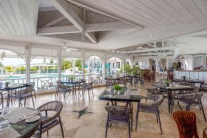 a restaurant with tables and chairs in a room at Sugar Hill Resort, Bananaquit in Saint Joseph