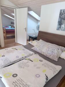 a bedroom with two beds and a bedspread on it at Apartments Justingerweg Bern in Bern