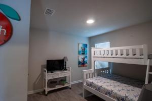 a childs bedroom with a bunk bed and a television at Off the Grid in Foley