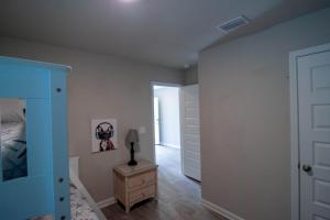 a bedroom with a bed and a lamp on a dresser at Off the Grid in Foley