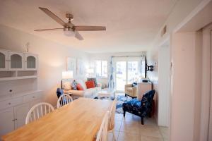 a kitchen and living room with a table and chairs at Salty Dune 2BR Beach Condo w Pools in Gulf Shores