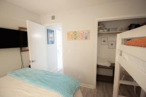 a bedroom with a bed and a bunk bed at Salty Dune 2BR Beach Condo w Pools in Gulf Shores
