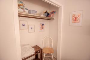 a closet with a chair and a wooden table at Salty Dune 2BR Beach Condo w Pools in Gulf Shores +29 photos