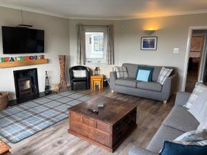 a living room with a couch and a coffee table at The Beach House Trearddur Bay in Holyhead