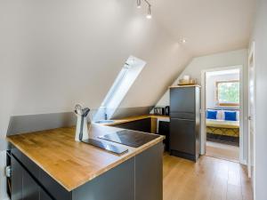 a kitchen with a sink and a refrigerator at Pond View Loft in Sudbury