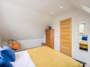 a bedroom with a bed with a yellow blanket at Pond View Loft in Sudbury +5 photos