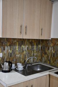 a kitchen with a sink and a counter top at Apartamente Antoni Shengjin in Shëngjin +65 photos