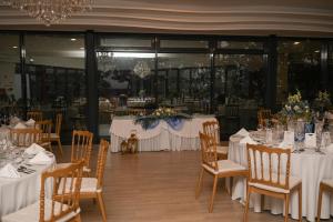 a set of tables with white tablecloths and chairs at Luna Hotel Turismo in Abrantes