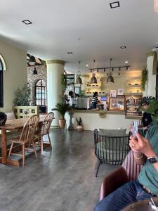 a person taking a picture of a table and chairs at Khlong bang phra boutique hotel in Trat