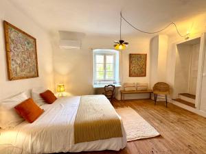 a bedroom with a large bed and a window at Chambre 2 personnes Maison Saint Jean in Château-Chalon