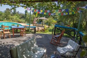 a patio with chairs and a table and a pool at Casa Chueca - DiVino in Talca