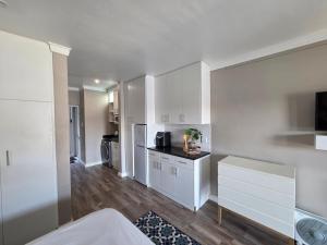a kitchen with white cabinets and a counter top at ShipsBell 5B in St Francis Bay