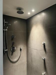 a bathroom with a shower with a glass door at Villa Kokeliko in Kuurne +28 photos