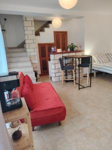 a living room with a red couch and a table at Studio Magnolia in Saint-Satur
