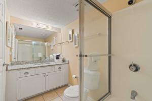 a bathroom with a shower and a toilet at Barefoot Getaway in Orange Beach +22 photos