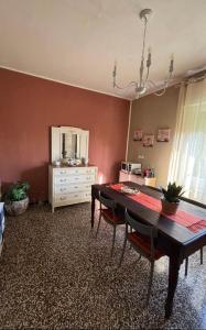a dining room with a table and a dresser at Casa Mina in Lavagna