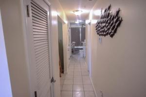 a hallway with a hallway leading to a room with a hallway at Sunsets and Palms in Gulf Shores