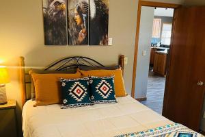 a bedroom with a bed with two paintings on the wall at Happy Jack in Rapid City