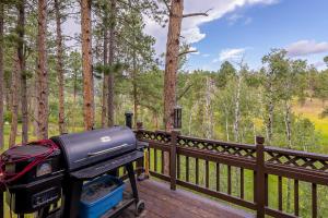 a grill sitting on a deck next to a fence at Happy Jack in Rapid City